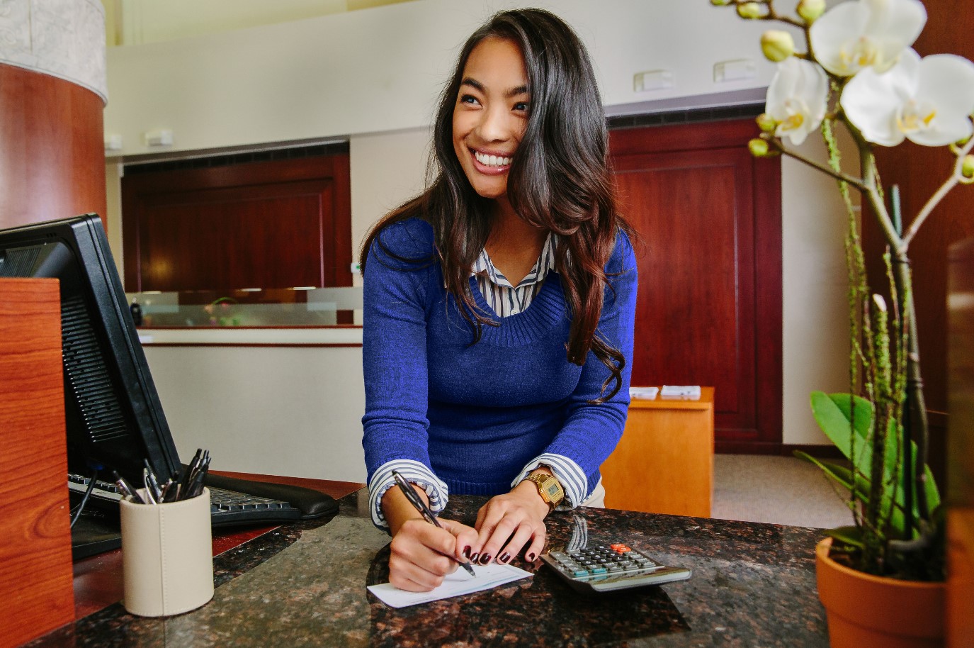 Woman signing check and smiling