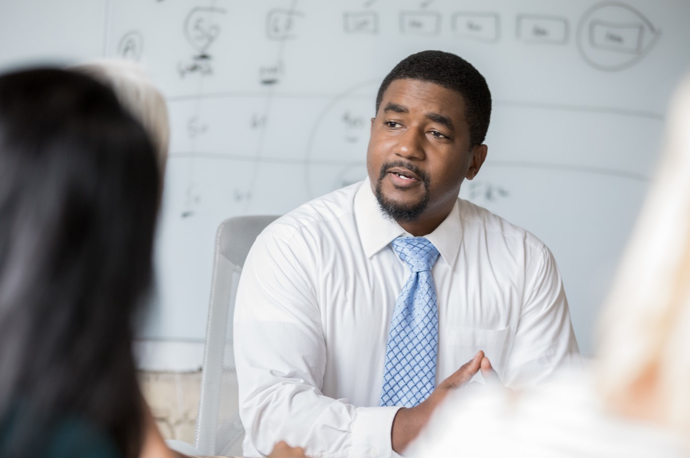 Man in meeting facing forward