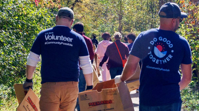 Image two people smiling with volunteer t-shirts